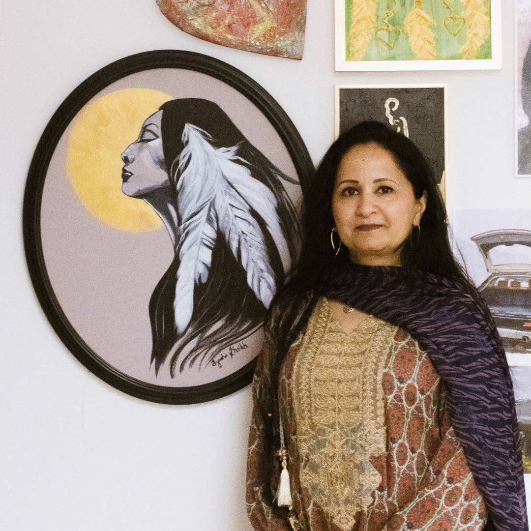 photo of artist Ayesha Shaikh with her art piece "survivor"